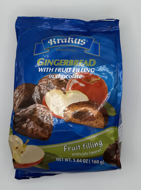 Bag of Krakus gingerbread cookies with fruit filling covered in chocolate, featuring images of apples and chocolate-coated cookies on the blue packaging.