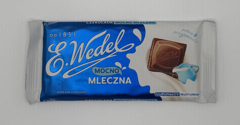 Front of E.Wedel Mocno Mleczna extra milk chocolate bar in blue and white packaging with chocolate piece and milk pitcher illustration.